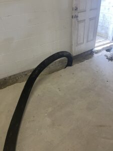 A black hose placed into the ground