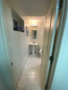 A white door leading to a bathroom