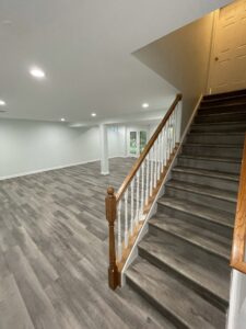 A basement room with dark brown flooring