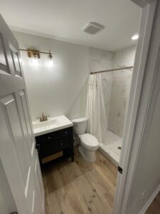 A bathroom with white fixtures and surfaces