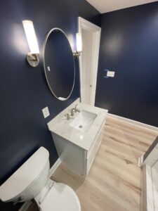 A bathroom with dark blue walls