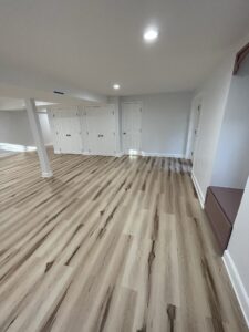 A gray basement with wooden flooring
