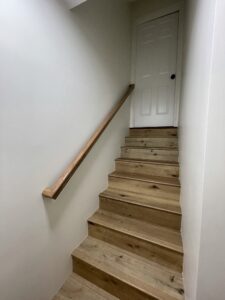 A wooden staircase leading to a door