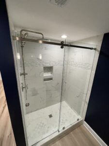 A white shower in a dark blue bathroom