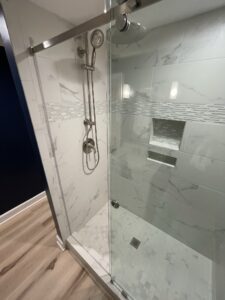 A shower with an open glass door
