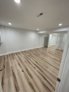 A basement with gray walls and white open doors