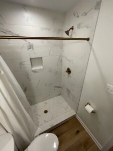 A shower with marble surfaces