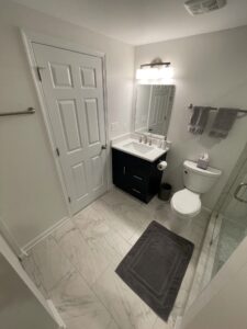 A small bathroom with a wall light