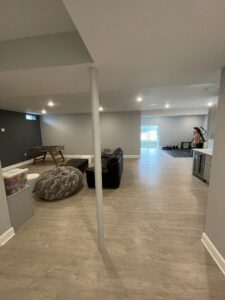 A wide basement room with furniture