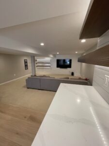 Countertops of a kitchen showing the sofa and TV