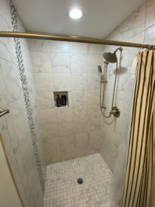 A shower area with brown curtains