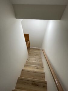 A wooden staircase leading to a lower level