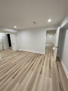 A basement with gray walls and open doors